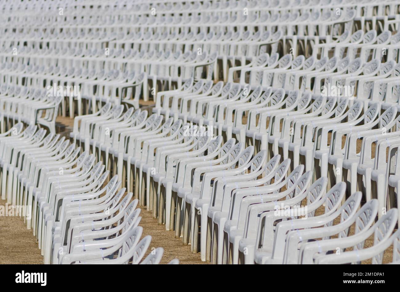 White plastic chairs arranged in rows in an open air concert area Stock ...