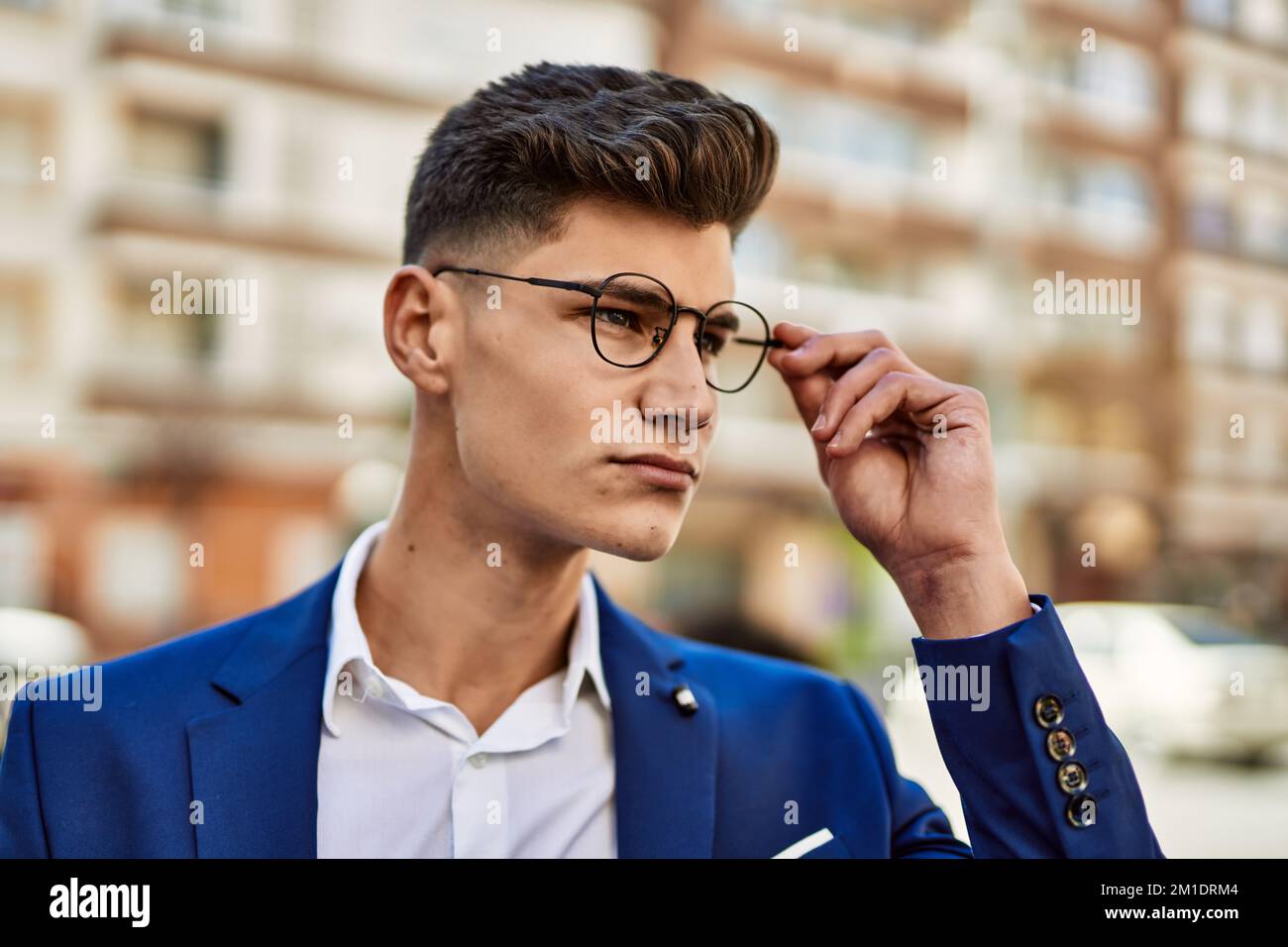 Young man relaxed wearing suit and glasses at street Stock Photo - Alamy