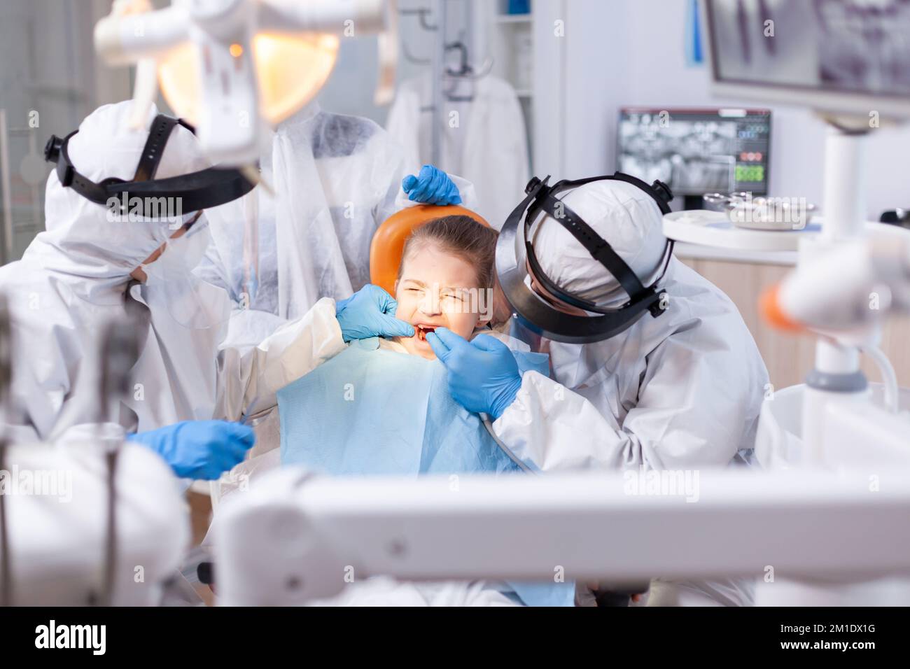 Little girl with eyes closed because of pain in the course of cavity