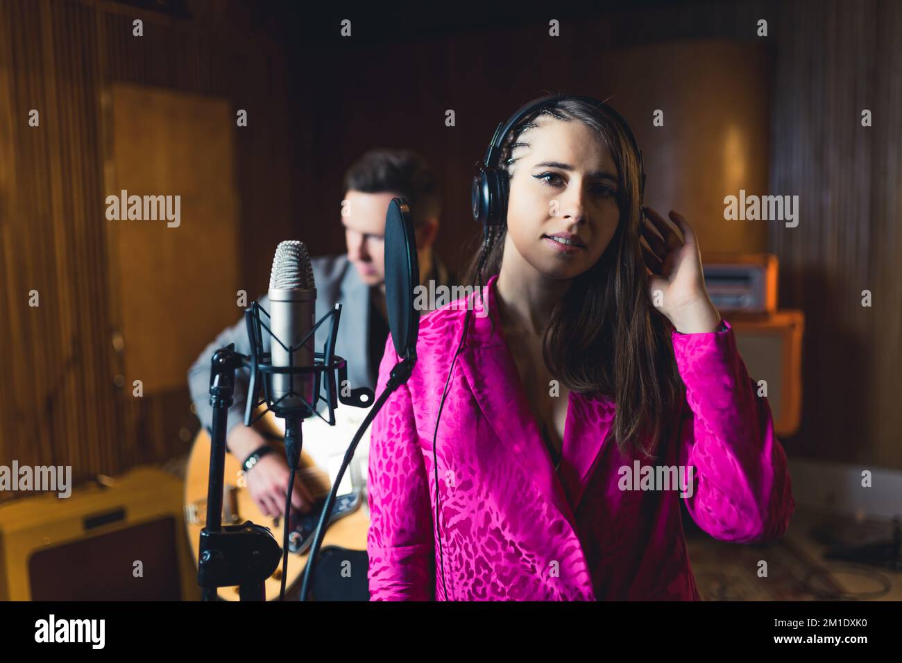 Female singer recording new song. Indoor portrait of caucasian young ...