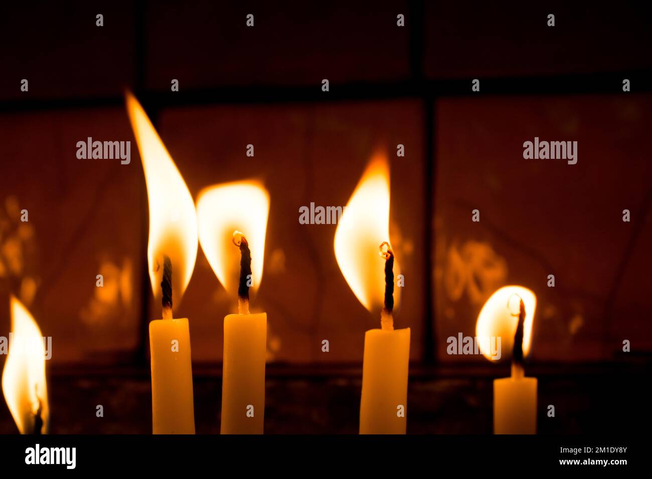 Burning candles with candle light in the dark Stock Photo