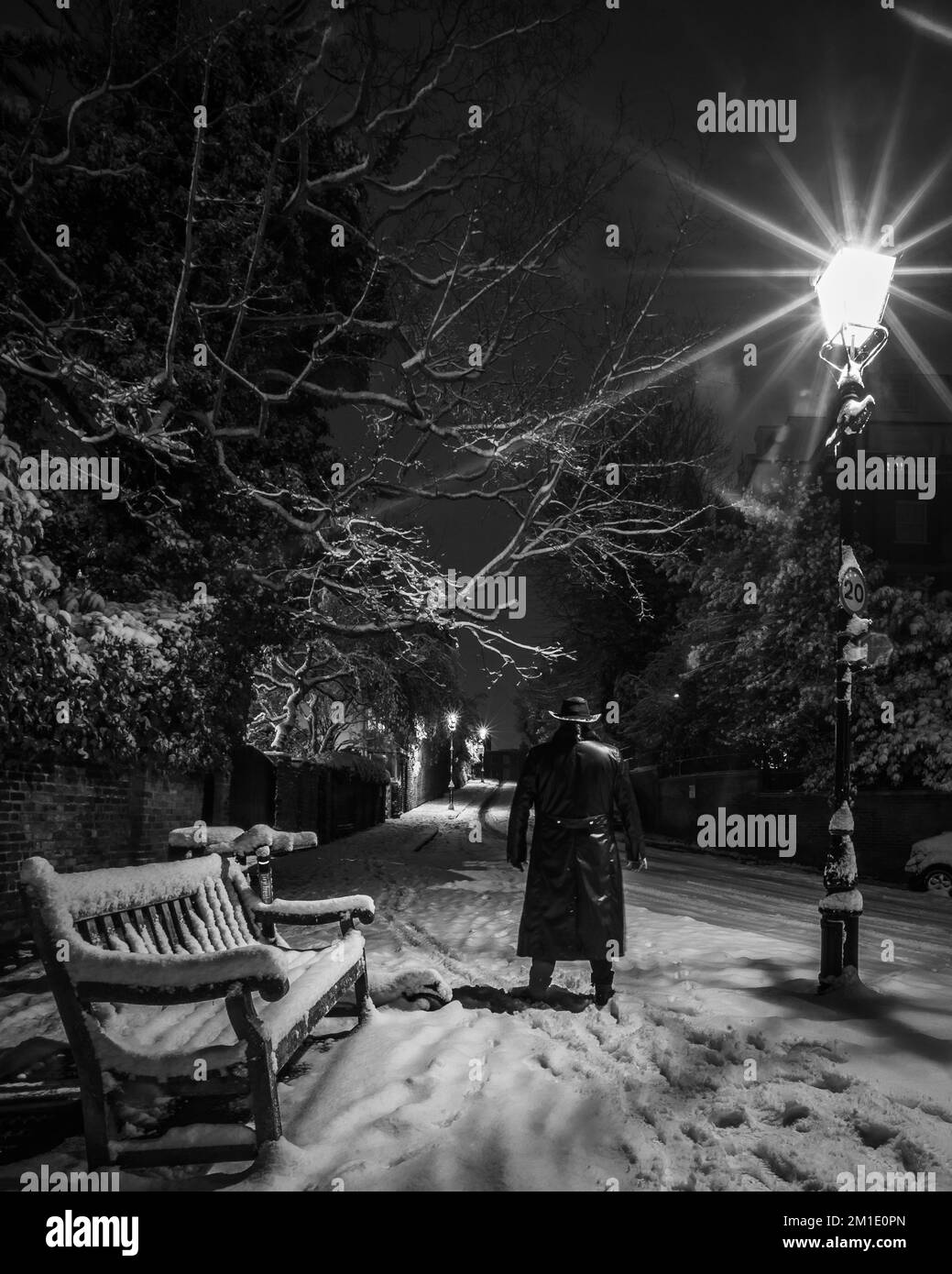 A black and white image of a man in the first snow in London of 2022. Stock Photo