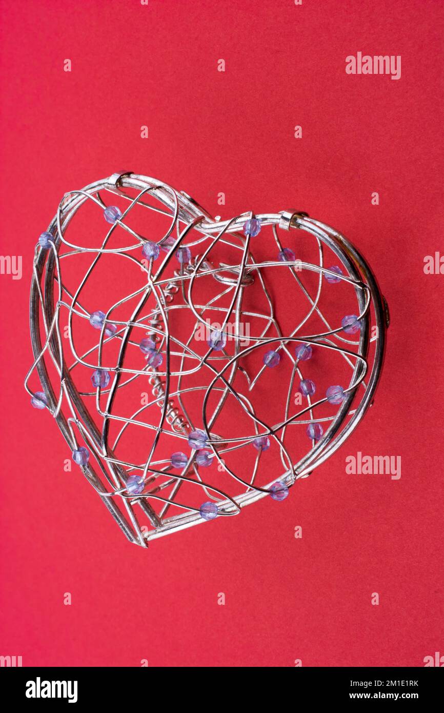 Heart cage on a red background Stock Photo
