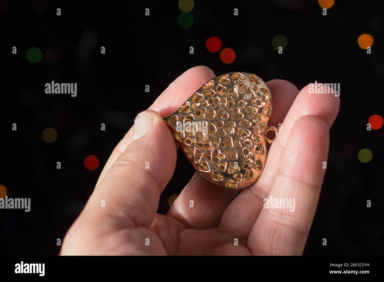Heart shape icon in hand on bokeh light Stock Photo