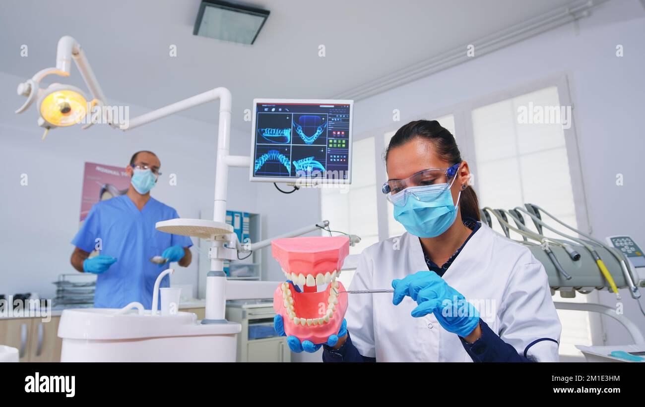 Patient pov of dentist showing correct way of cleaning teeth wearing in