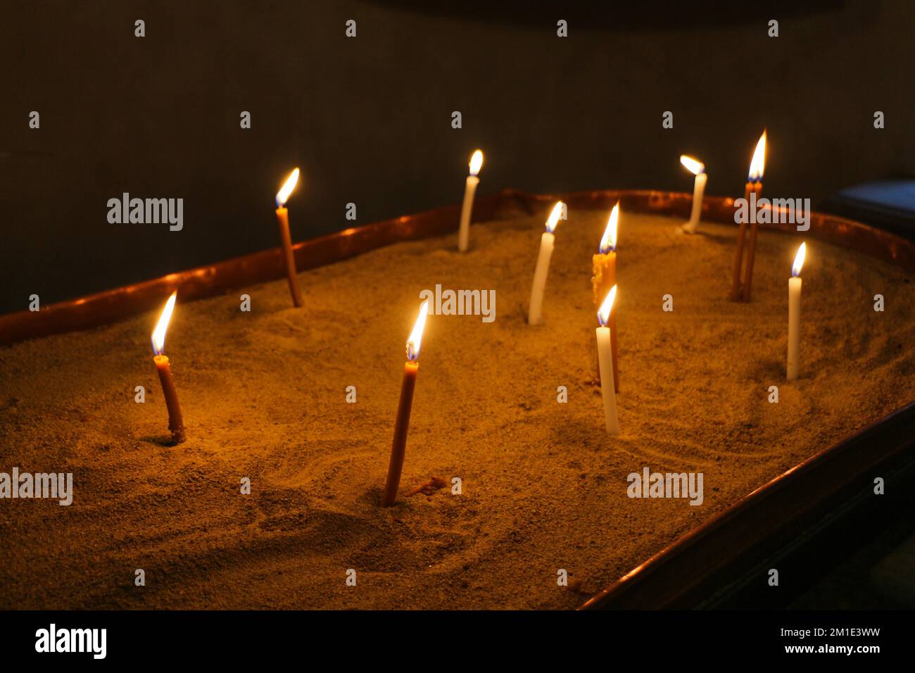 Candles burning over dark background in a church Stock Photo - Alamy