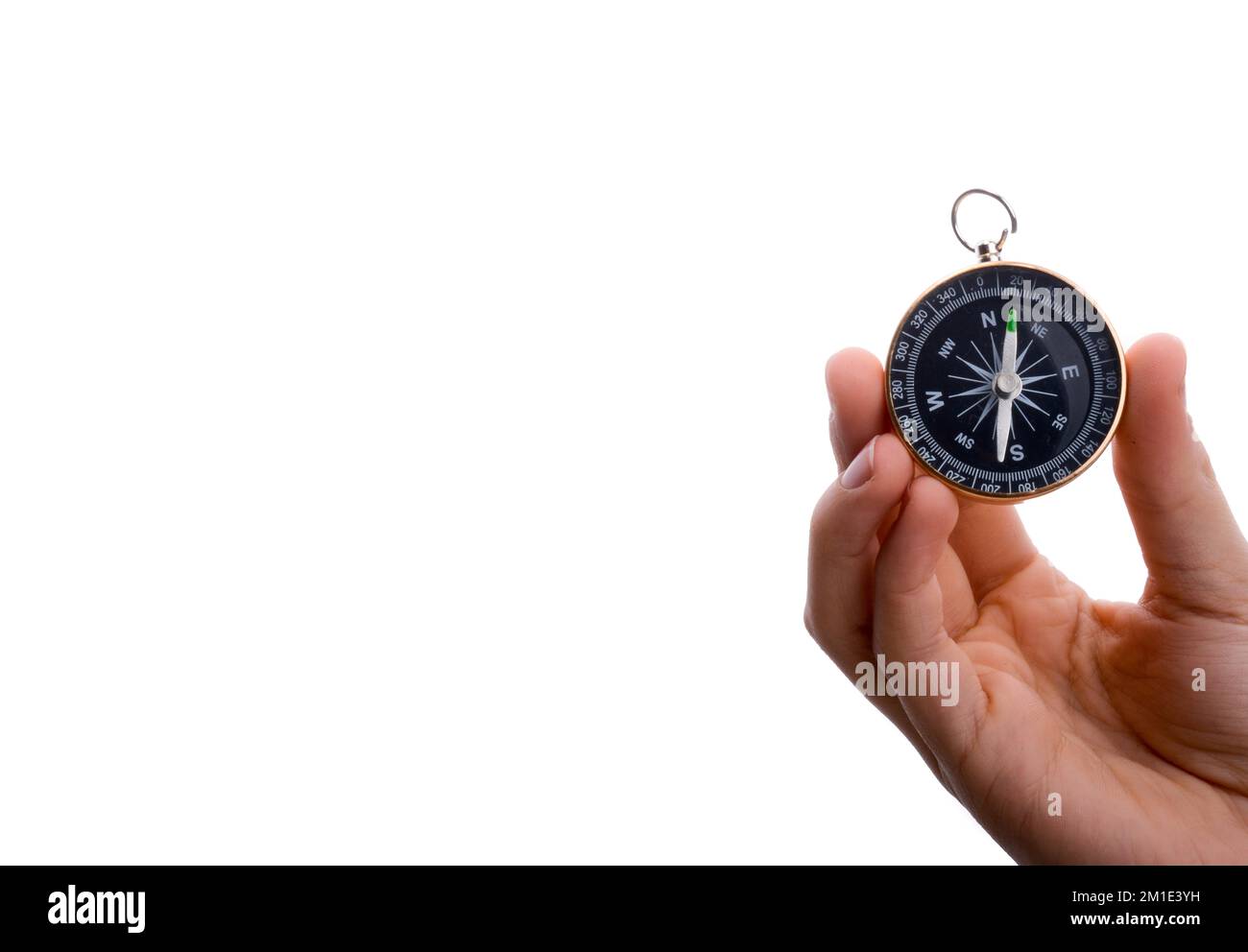Isolated compass in child's hand on a white background Stock Photo