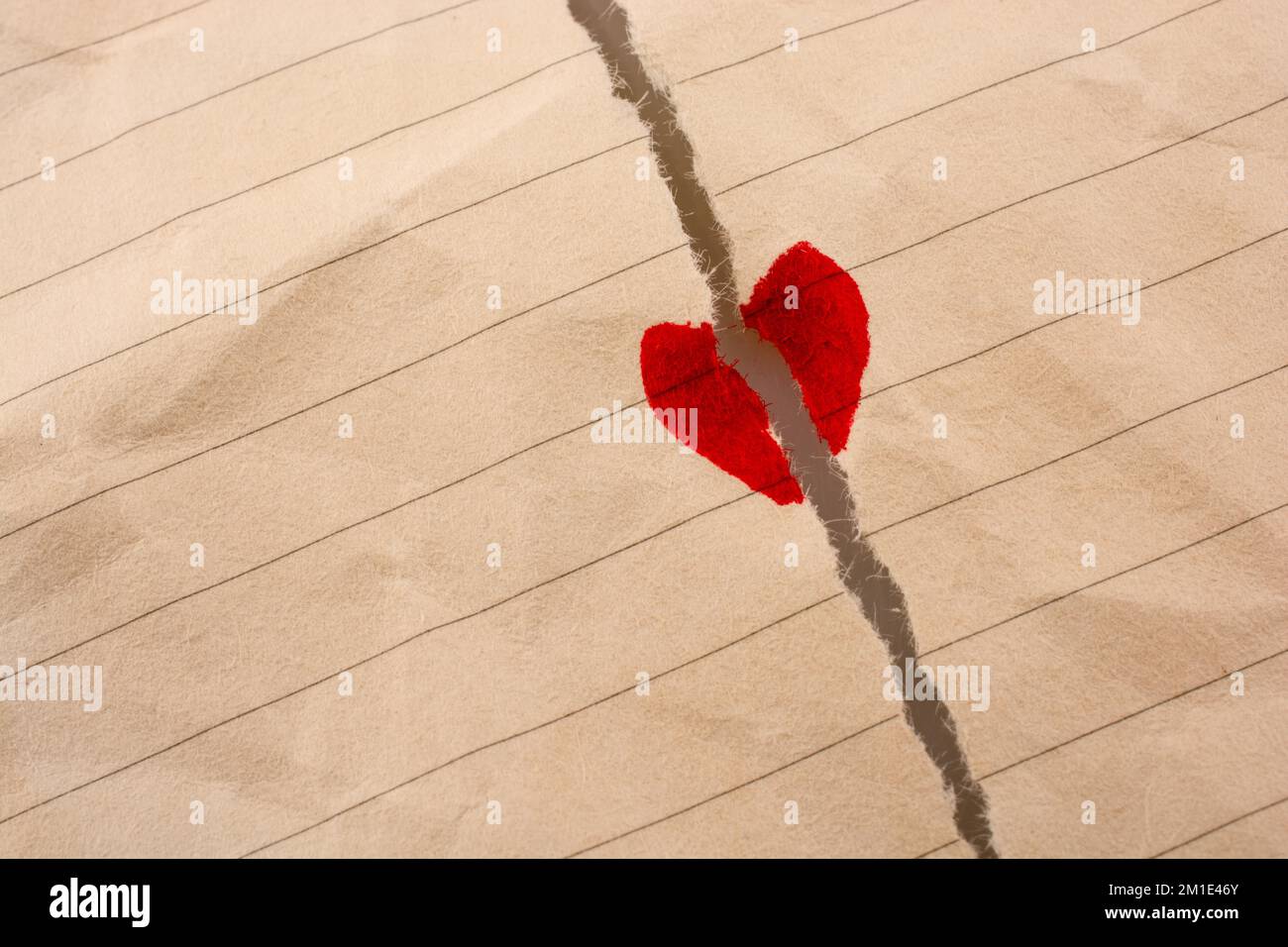 Torn paper with a heart shape says love Stock Photo - Alamy