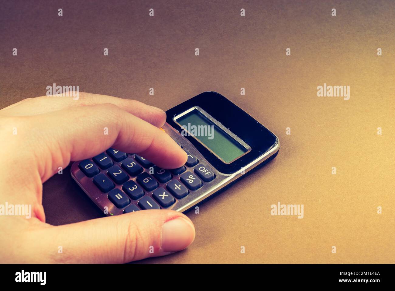 Electronic calculator device with keyboard and display in hand Stock Photo