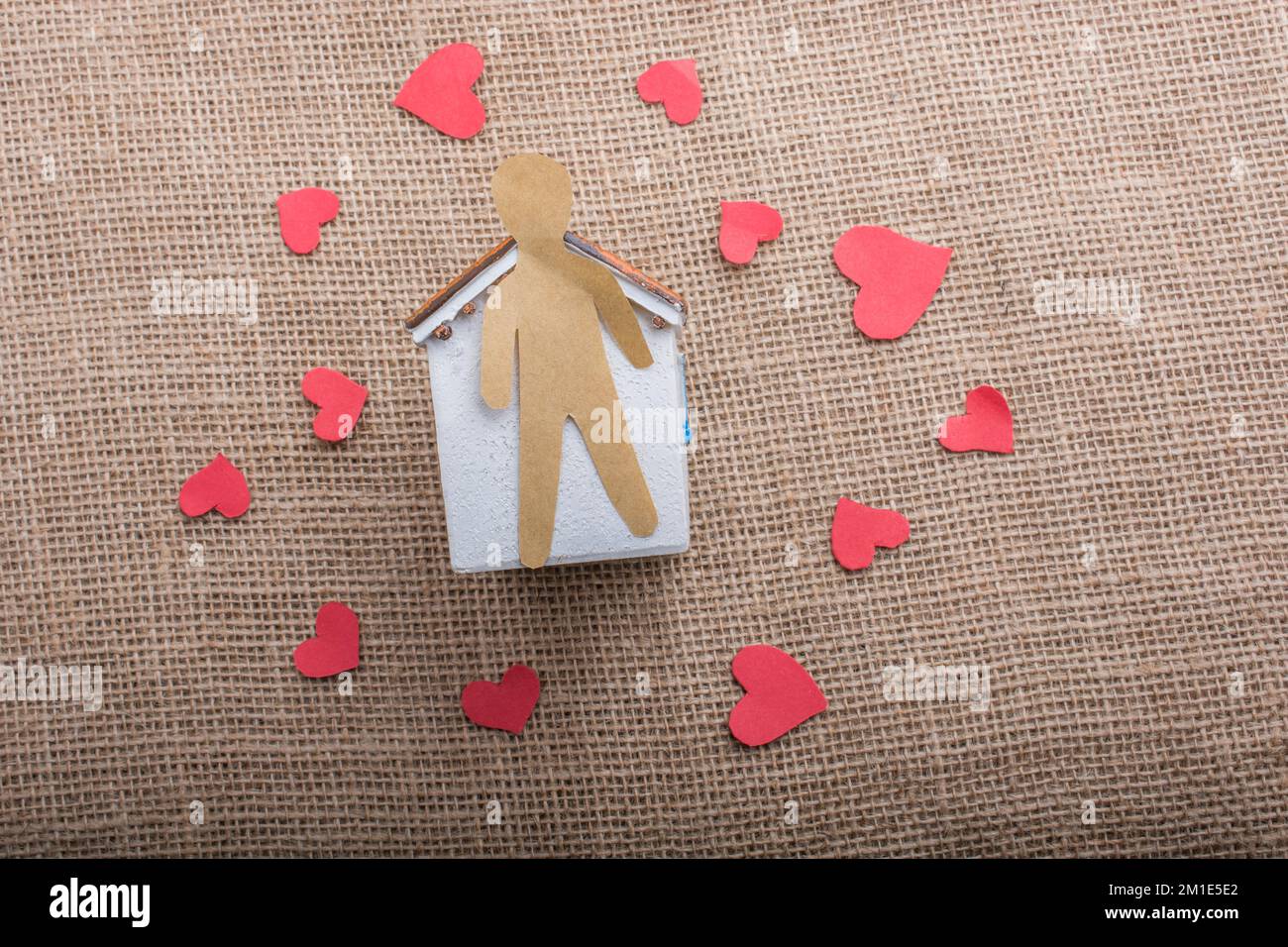 Heart shaped icons and paper house on canvas Stock Photo - Alamy