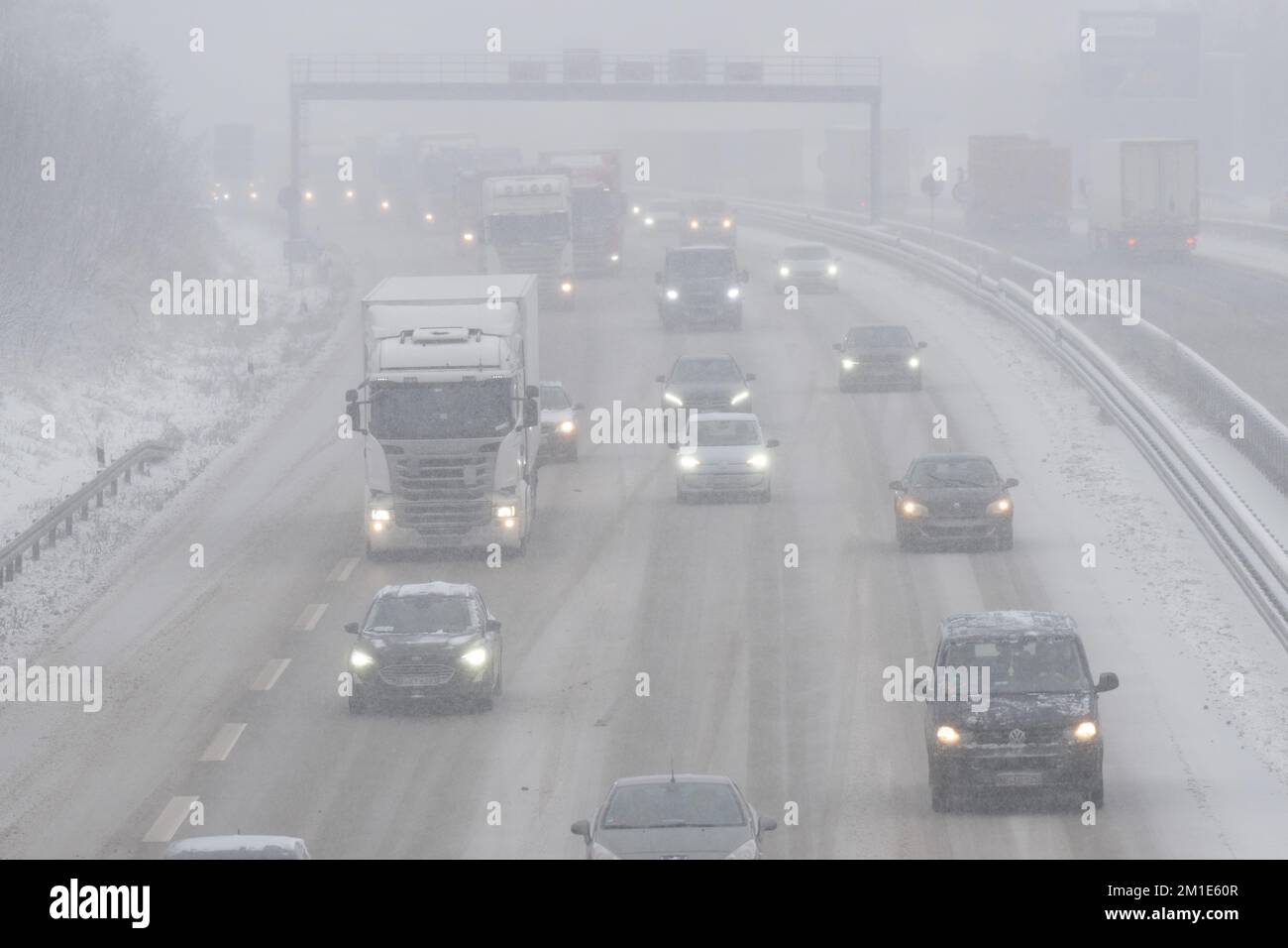 Dresden, Germany. 12th Dec, 2022. Cars and trucks are driving in heavy snow on the Autobahn 4 at