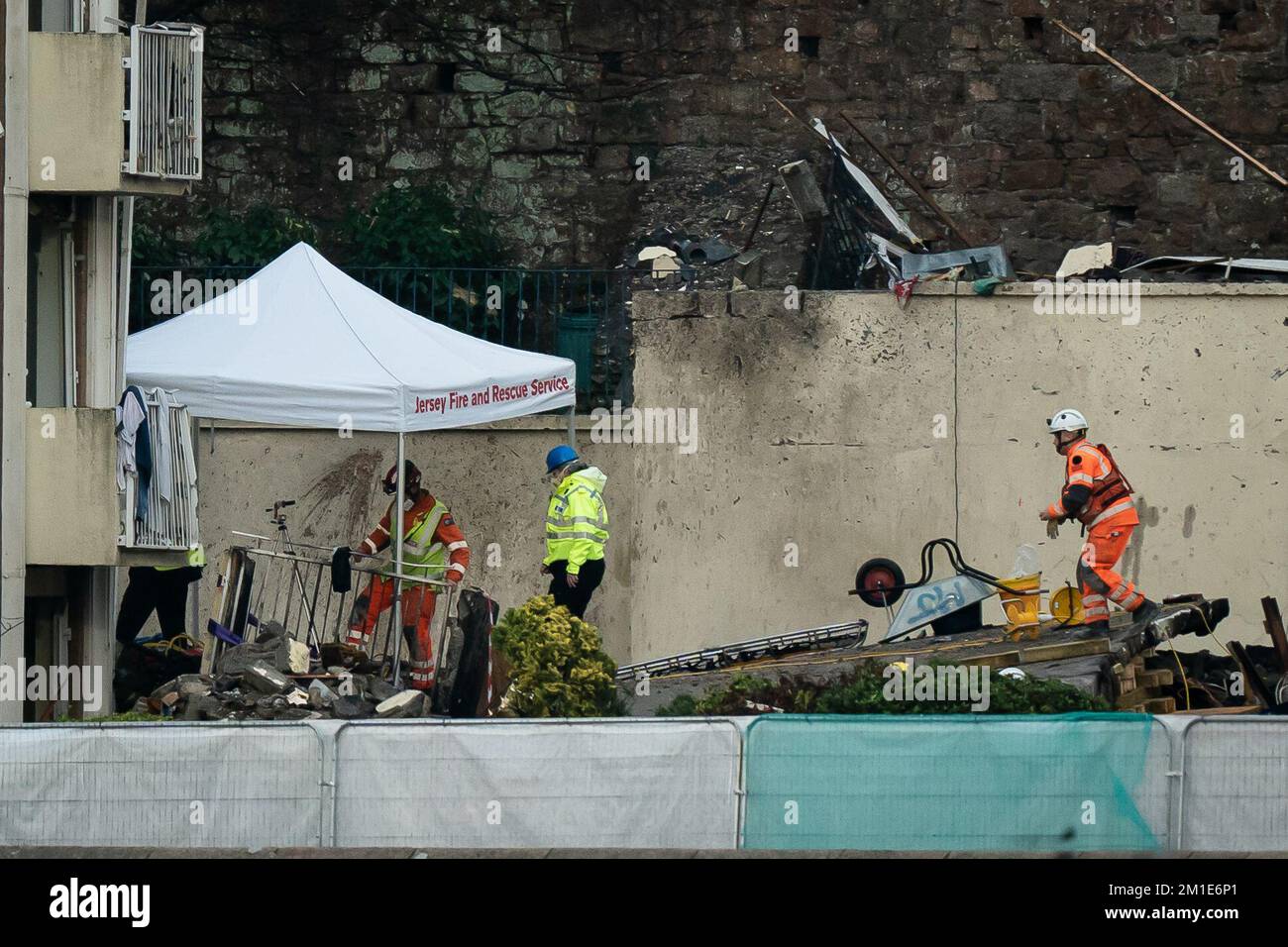 Emergency personnel at the scene of an explosion and fire at a block of