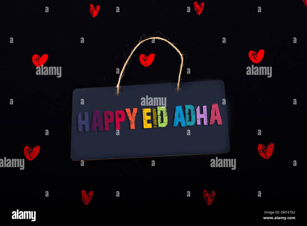 Rectangular shaped black notice board and red hearts on black background Stock Photo