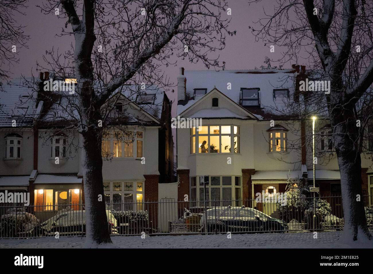 A person readies themself on a chilly Monday morning in a residential property after low temperatures and overnight snowfall on south London homes on Ruskin Park in SE24, on 12th December 2022, in London, England. Stock Photo