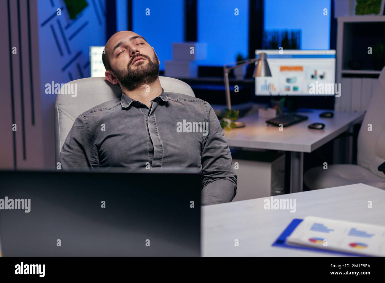 Exhausted hardworking businessman sleeping on chair. Workaholic