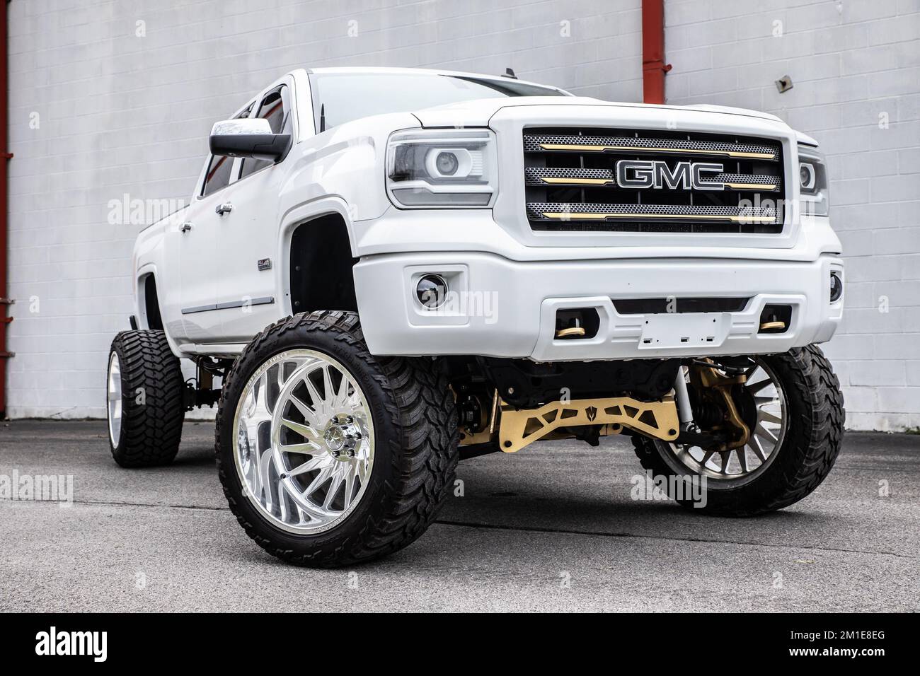 A white lifted GMC truck parked outdoors Stock Photo