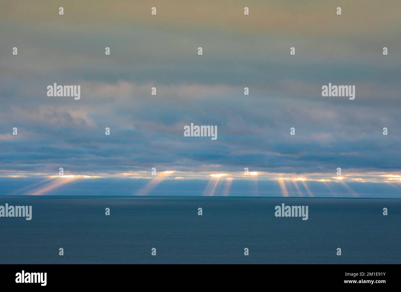 Sunrise with beams of light over the Atlantic Ocean Stock Photo - Alamy