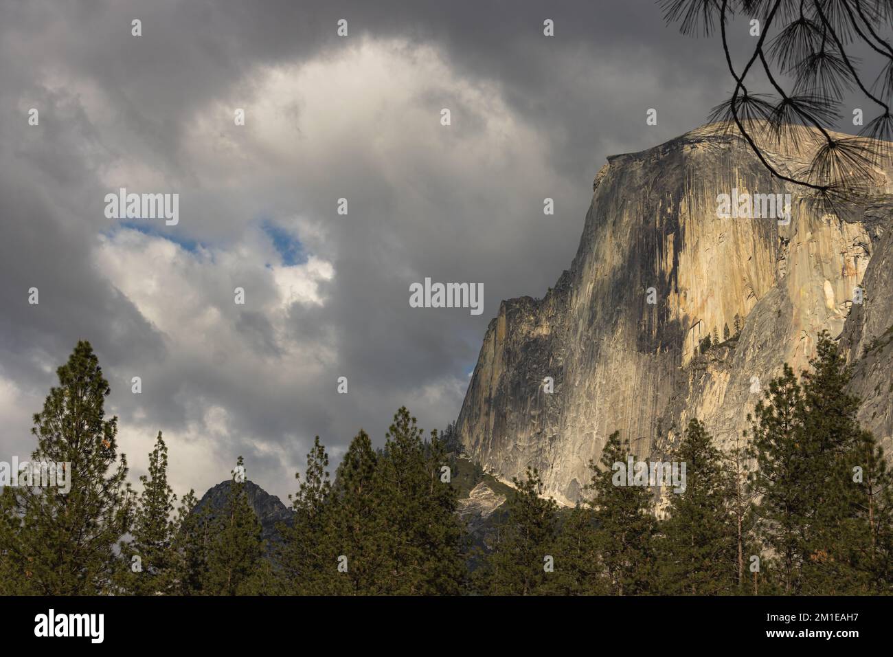 A breathtaking view of a rocky mountain under a dark cloudsy sky Stock ...
