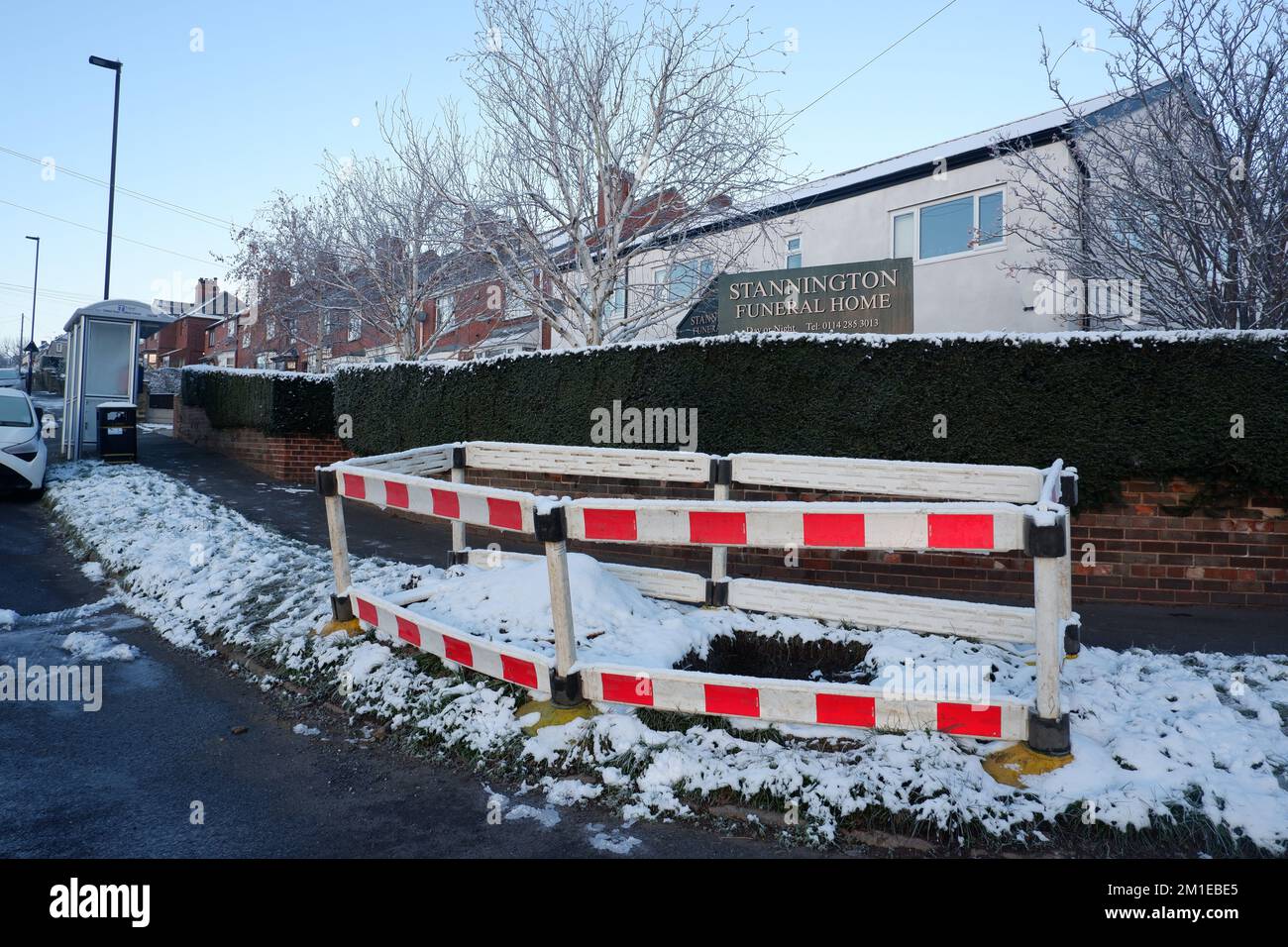 Barrier surrounding hole in the road in Stannington December 2022 after a burst Yorkshire Water pipe flooded a gas main cutting off gas to 2000 homes Stock Photo