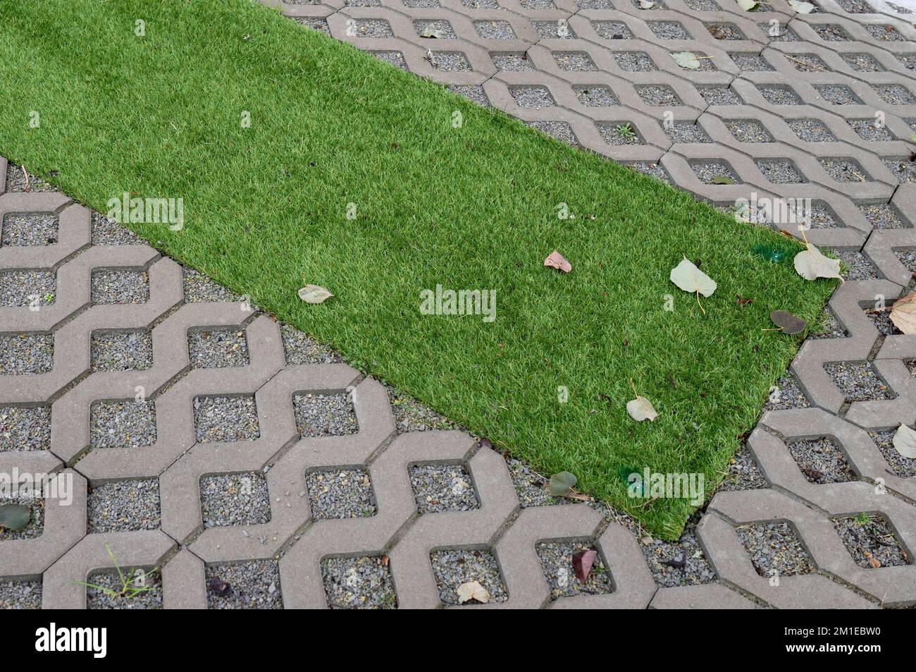 Top view of artificial grass and cobblestones Stock Photo