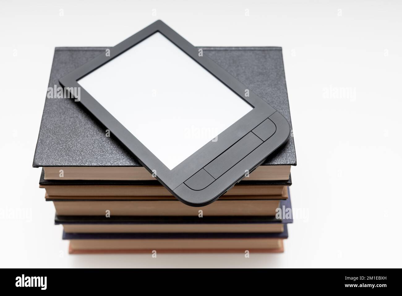ebook lies on a stack of paper books. electronic and paper book Stock