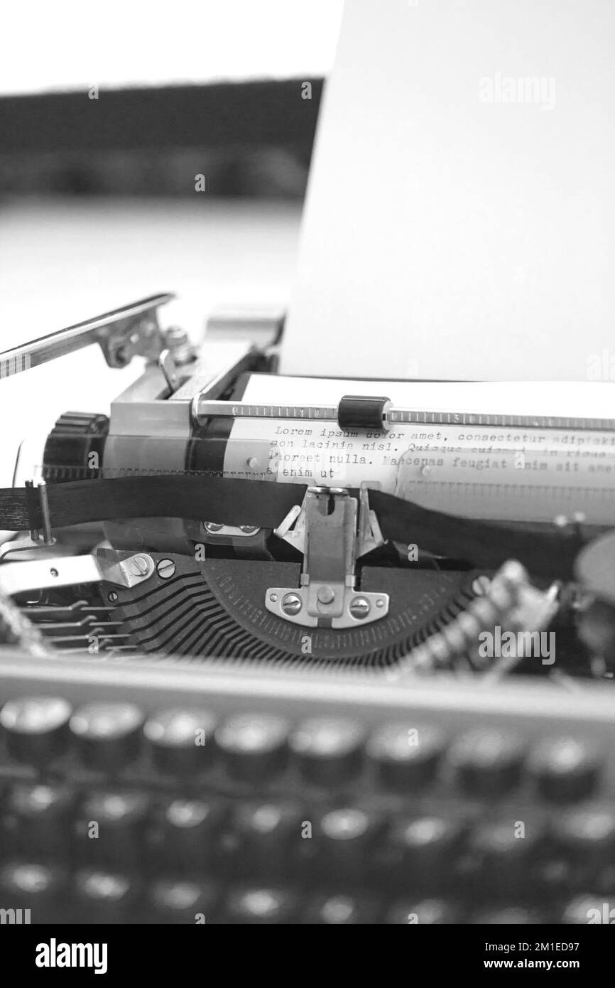 Vintage Typewriter machine with a sheet of paper and generic text typed Stock Photo