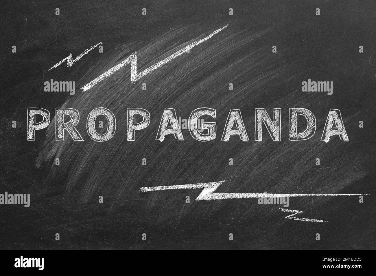 The word PROPAGANDA written in chalk on a blackboard. Information and