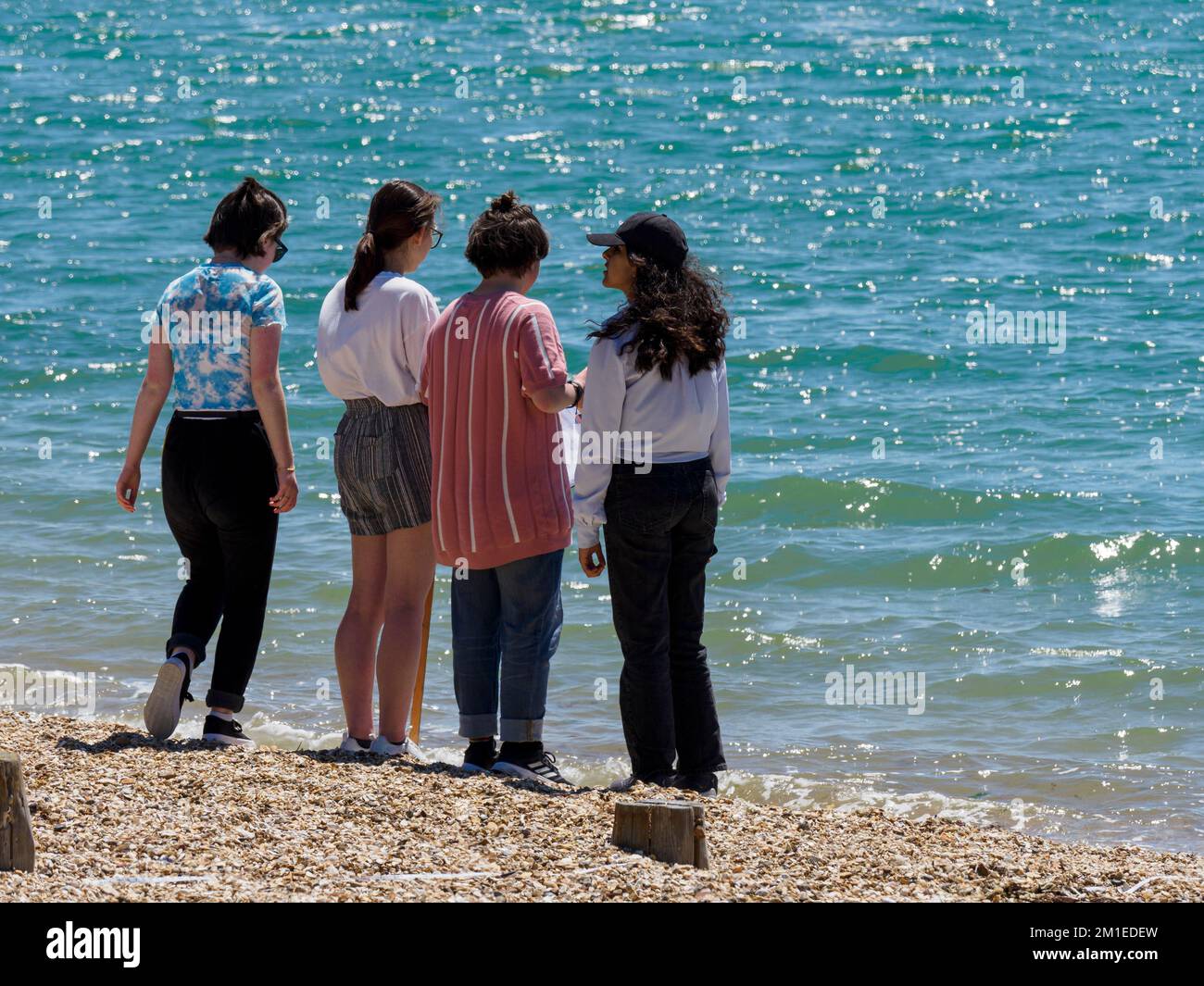 Students on a field trip to the beach, Lee-on-the-Solent, Hampshire, UK Stock Photo