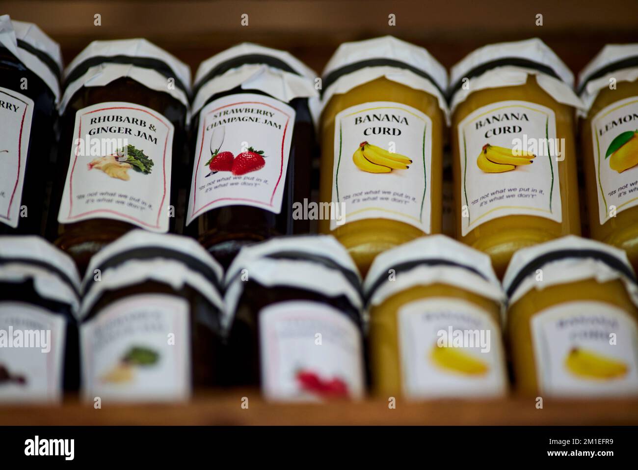 Market stall bannan Strawberry jams in jars Stock Photo