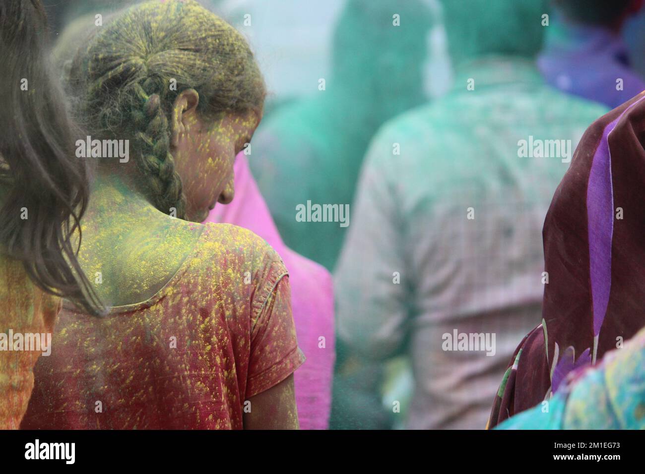 Delhi - Indian People face smeared with colors participate in Ganesh Visarjan Stock Photo