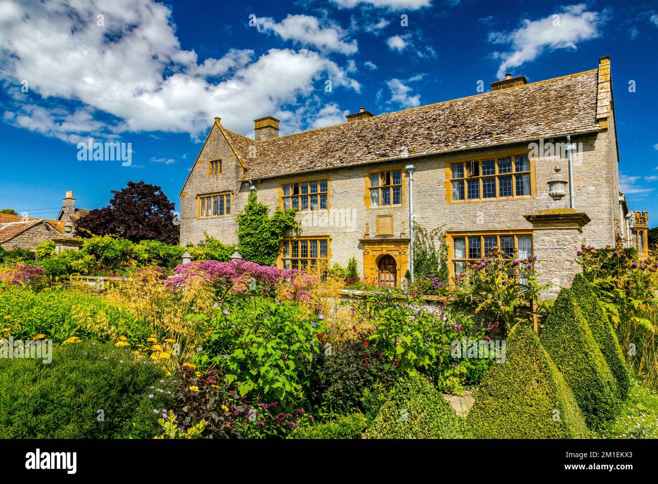 The colourful Cutting Garden and the west front of Lytes Cary Manor, nr