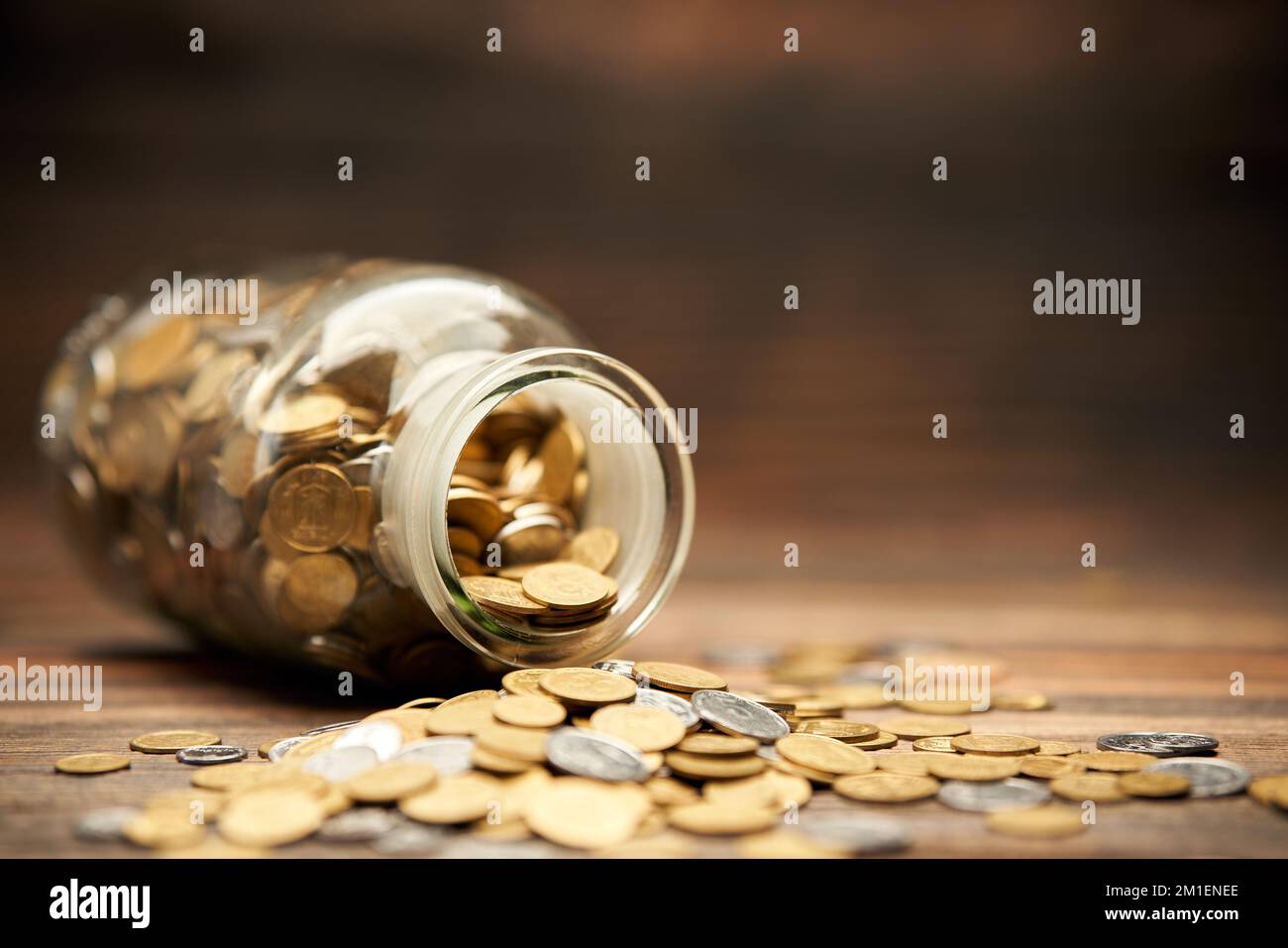 Glass jar filled of golden coins. Money, finance, retirement, investment concept Stock Photo