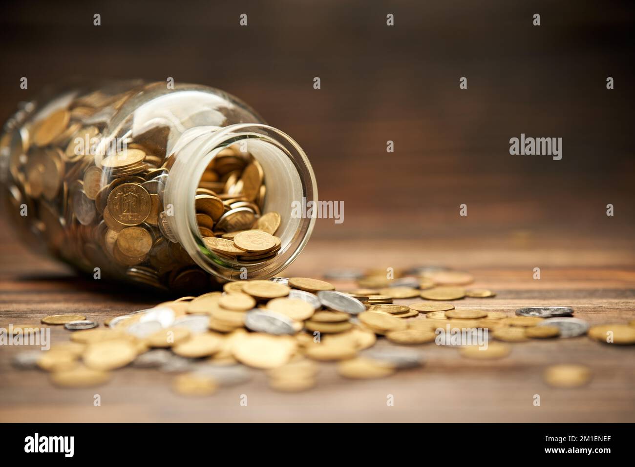 Glass jar filled of golden coins. Money, finance, retirement, investment concept Stock Photo