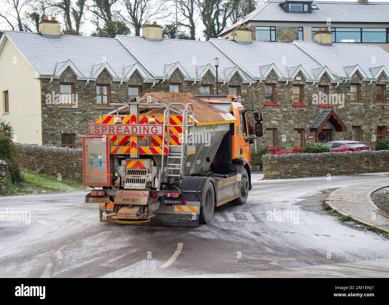 Gritter lorry spreading road salt on ice covered roads in Union Hall, Ireland. Stock Photo