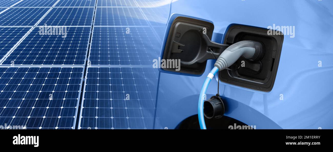 Close up of electric car with a charging cable and solar panels Stock ...