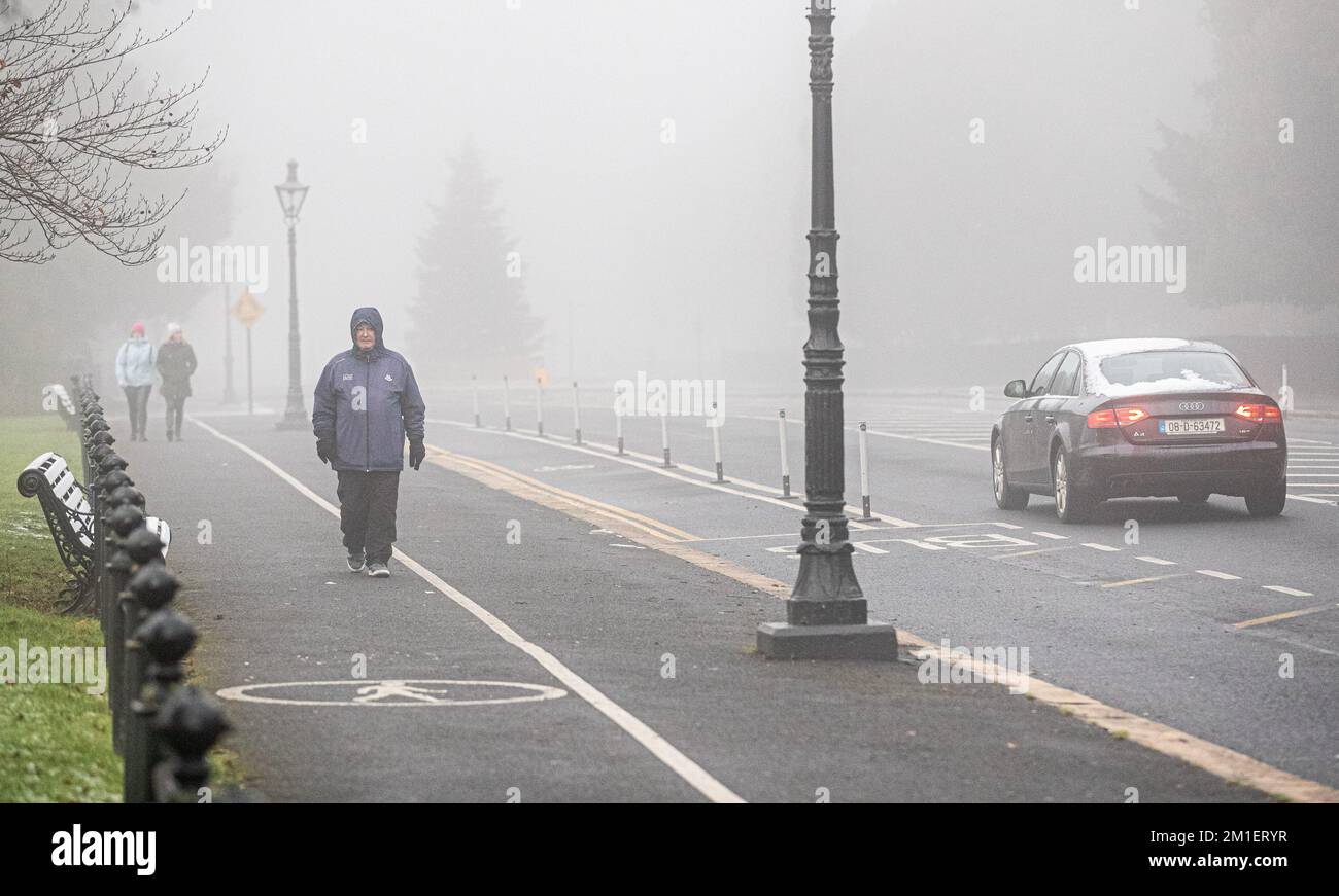 People navigate thick fog in Dublin City as the Irish Met office issued