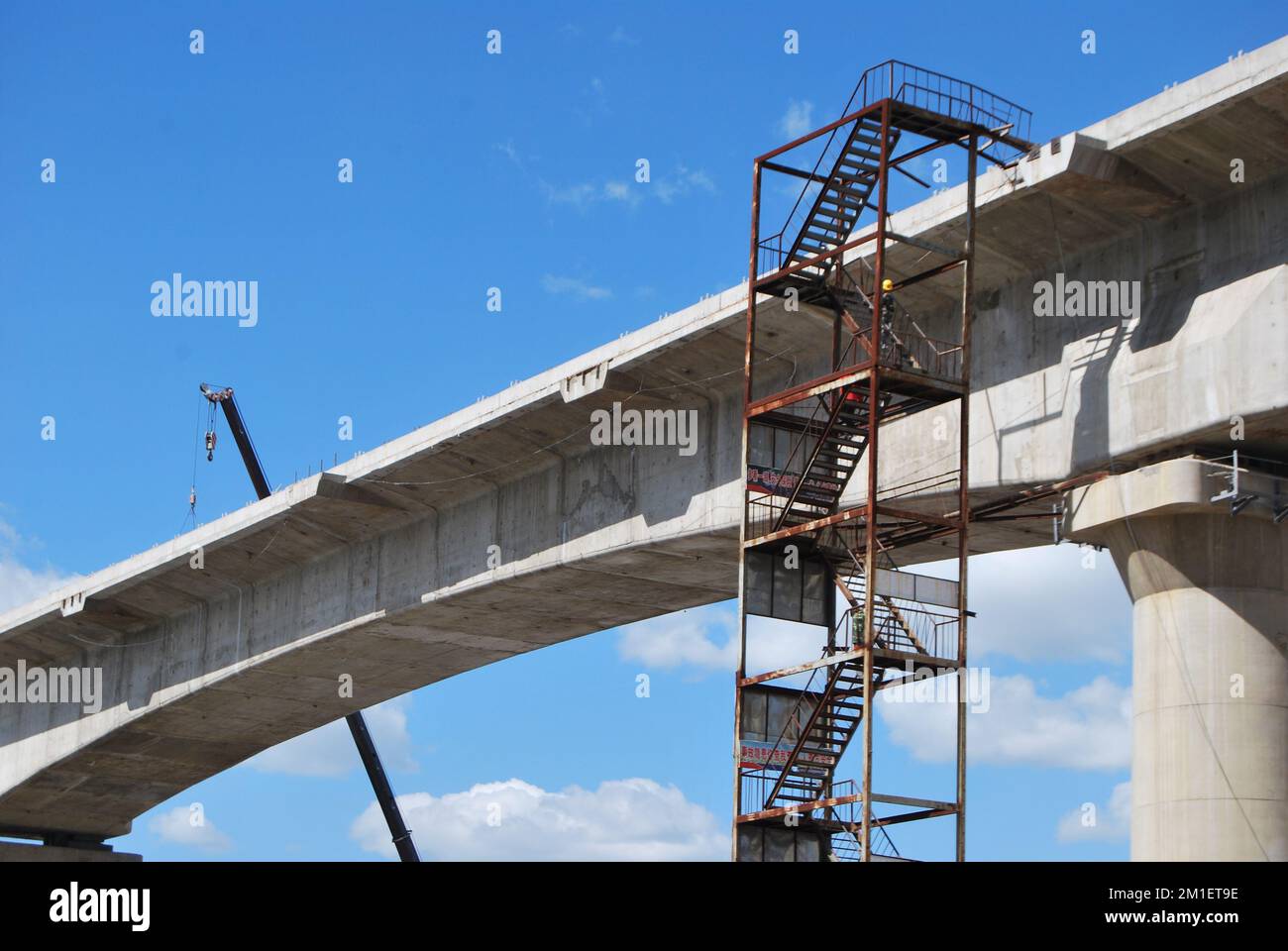 A low-angle shot of a bridge being constructed in an urban residential ...