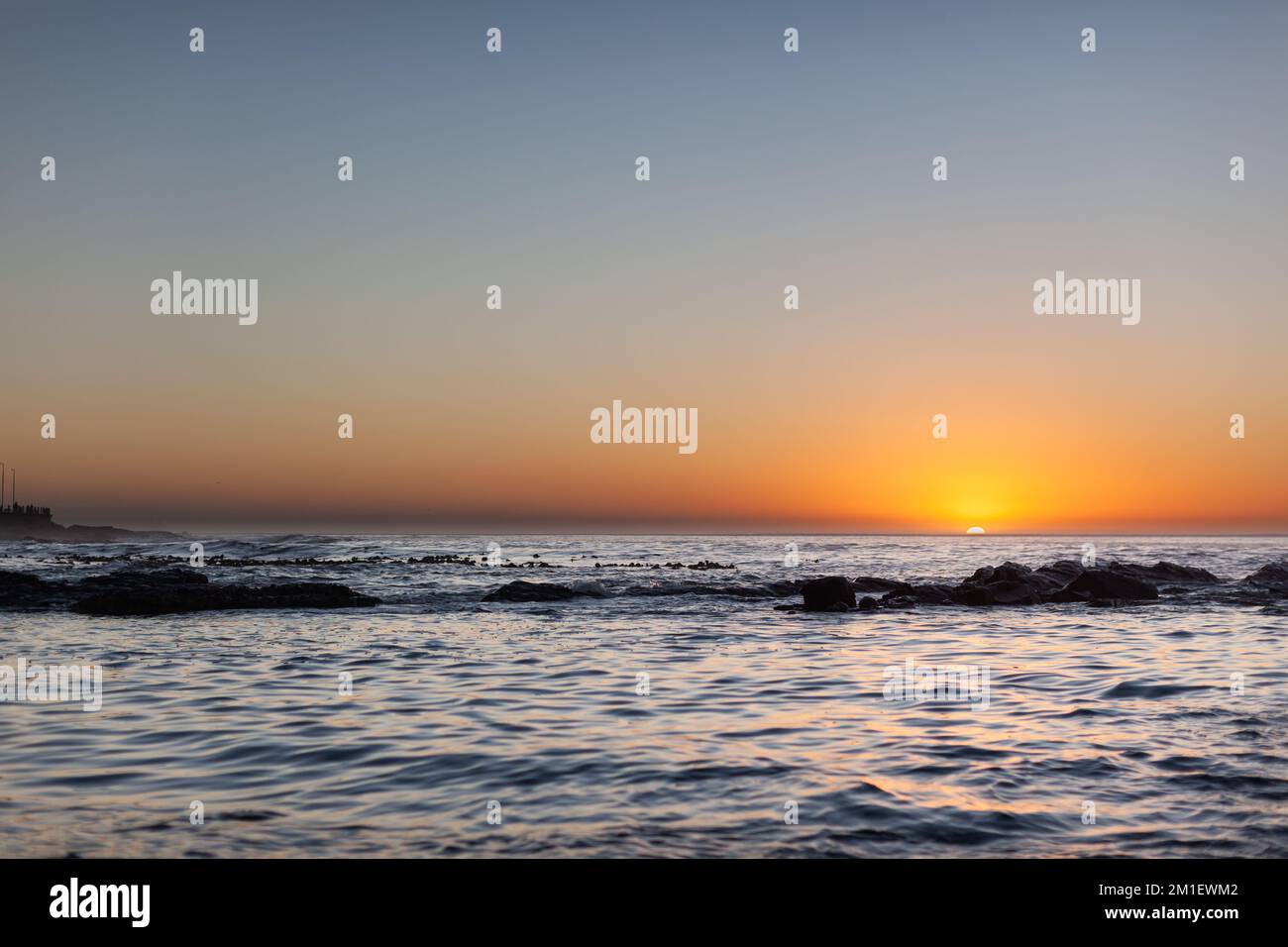 Beautiful Sunset and Calm Sea in Sea Point Cape Town Africa Stock Photo