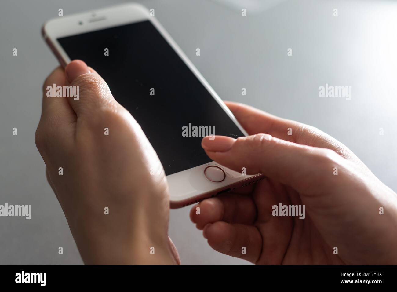 hands holding pressing smartphone buttons Stock Photo