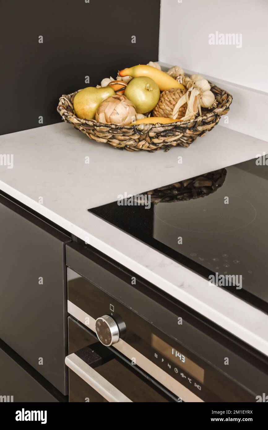 some food in a bowl on the stove top and an oven with two burners next