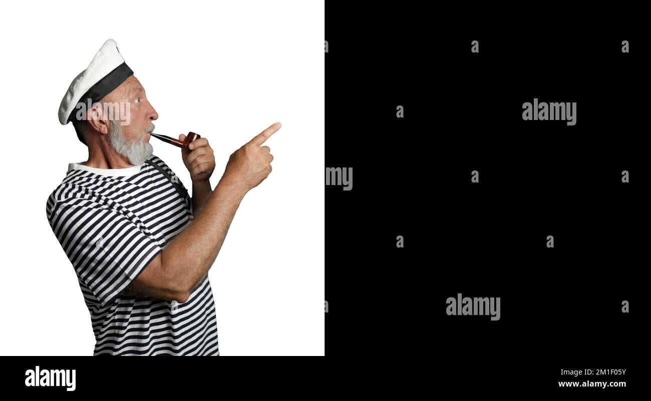 Cheerful sailor in profile on a black and white background. An old sailor with a smoking pipe and a raised index finger. Banner Stock Photo
