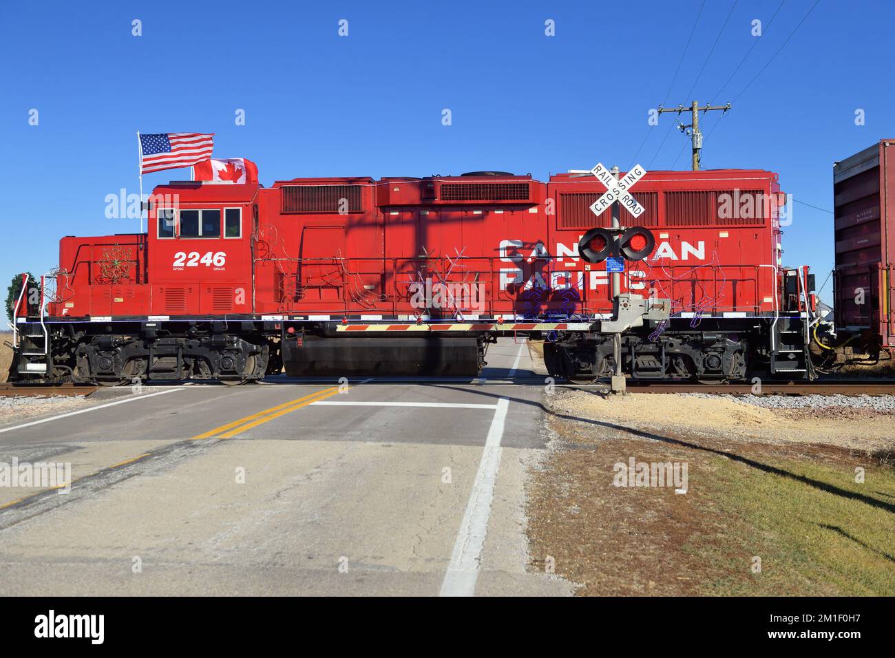 Hampshire, Illinois, USA. With flags unfurled on the lead locomotive, the Canadian Pacific Railway (CP) Holiday Train while moving between its schedul Stock Photo