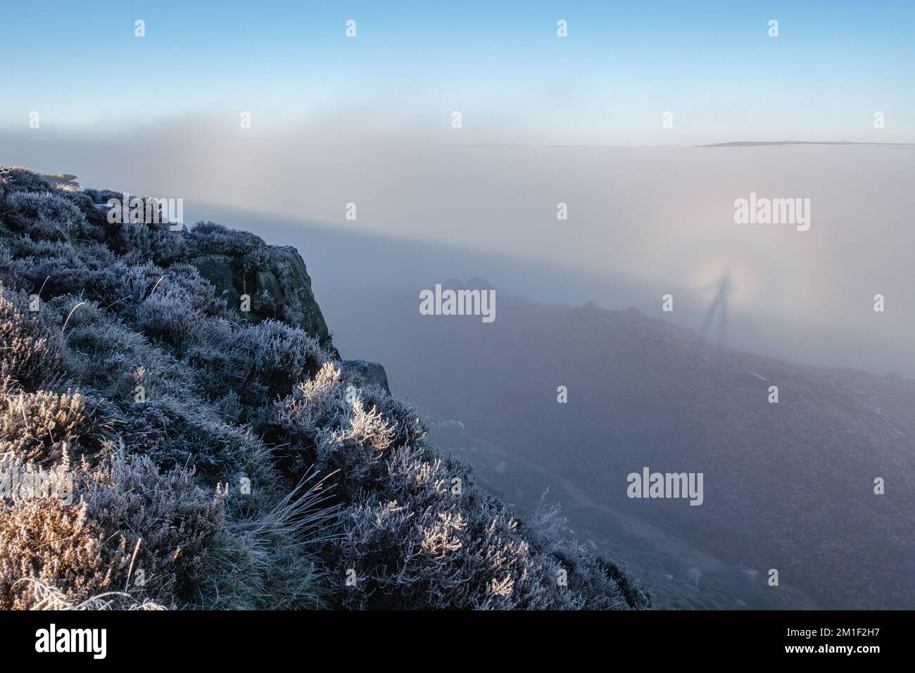 12 December 2022: Rare brocken spectre weather phenemonon delights walkers on Ilkley Moor in a cloud inversion with sunshine above the foggy town below for anyone venturing on the moors this morning. Ilkley, West Yorkshire, England. Credit: Rebecca Cole/Alamy Live News Stock Photo