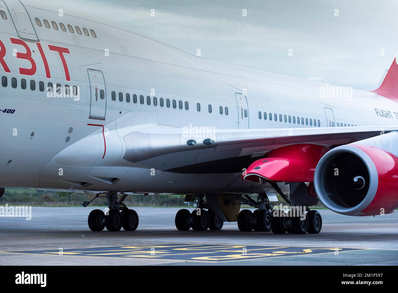 A closeup close up view of the red launch pylon under the wing of the Virgin Orbit, Cosmic Girl, a 747-400 converted to a rocket launch platform taxii Stock Photo