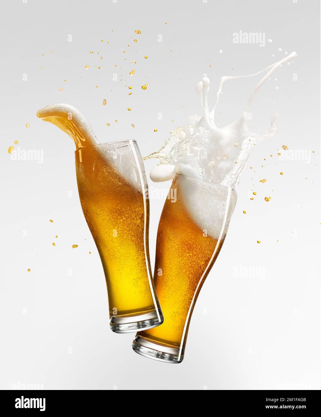 Foam splashes. Two glasses with lager foamy beer isolated over grey background. Concept of alcohol, oktoberfest, drinks Stock Photo