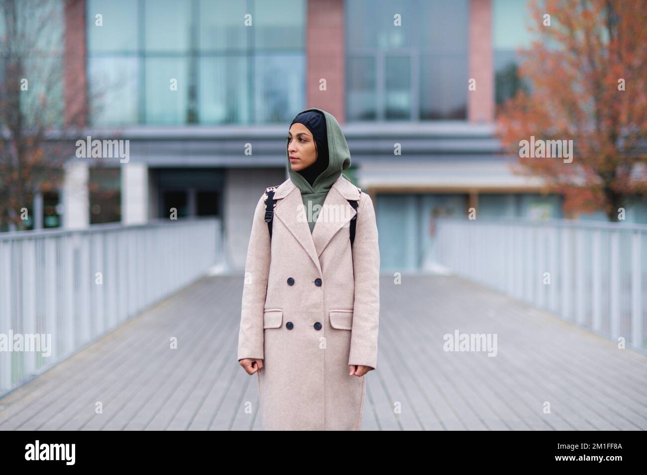 Young multiracial woman standing in a city bridge. Stock Photo