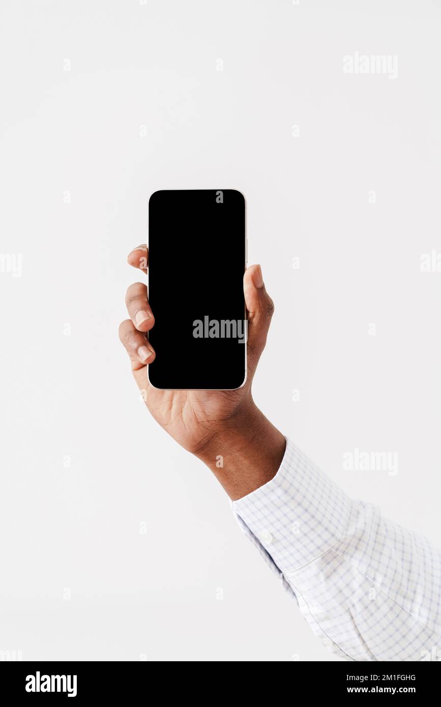 Photo of black man's hand with mobile phone isolated over white background Stock Photo