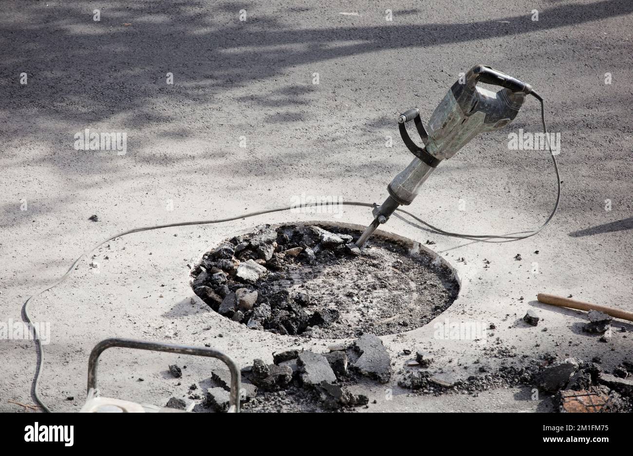 hammer drill in asphalt on site gasoline generator with tools