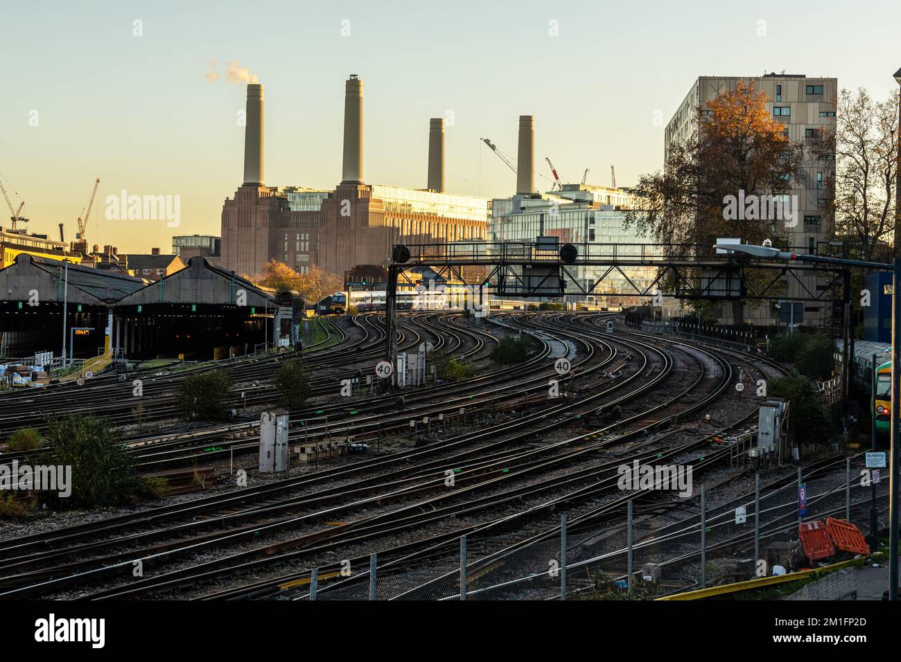 Train tracks outside Victoria Station, a newly renovated Battersea Power Station looms in the background. London Dec 2022. Stock Photo