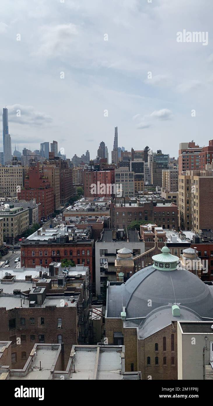 An aerial cityscape view with old and new buildings against a cloudy ...